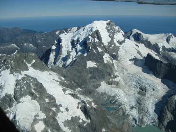 Mt Tutoko and the Donne Glacier in Fiordland. At the bottom of the image, you can see the glacier ice is calving into a lake.